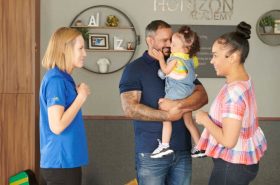 New Horizon Academy childcare teacher helping new family transition their child into daycare comfortably